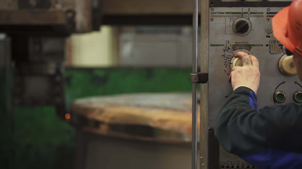 Worker Operating a Machine in a Factory