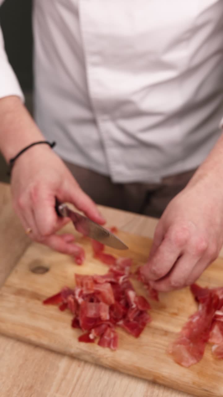 el chef está cortando prosciutto.