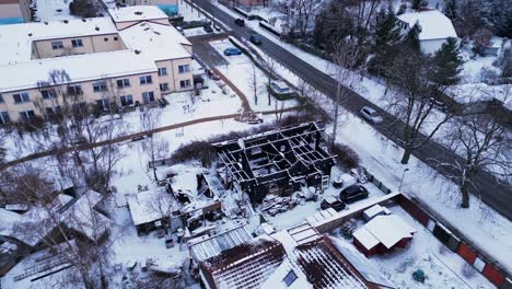 fire-burned-house-in-village,-winter-Snow