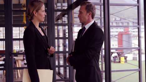 businessman and businesswoman talking together