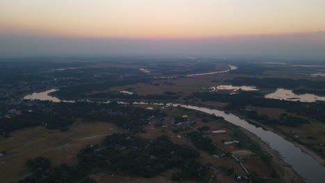 panoramic aerial view of snake like shape river in the village of bangladesh