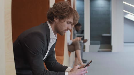 portrait of smiling caucasian businessman using mobile phone