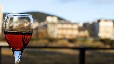 wine glass distorts background creating an illusion