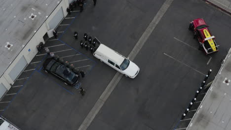 aerial drone of police officers saluting a casket