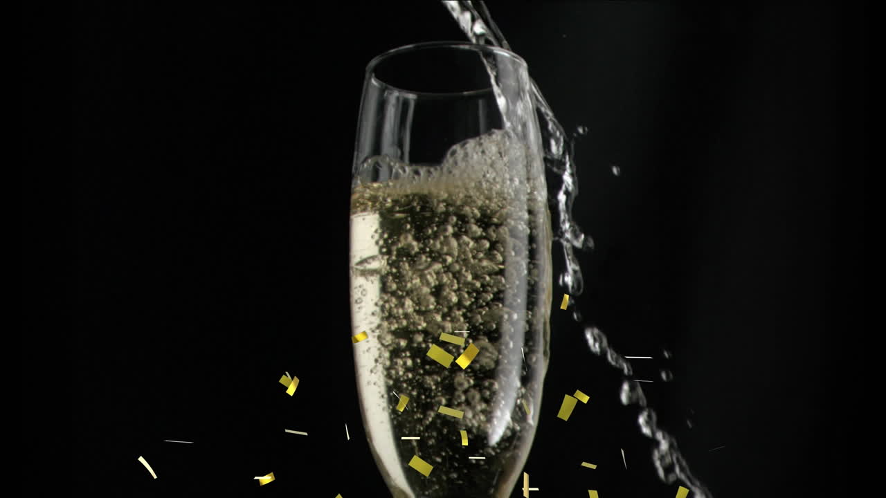 검은색 바탕에  ⁇ 페인 잔 위에 떨어지는 금색 콘페티의 애니메이션