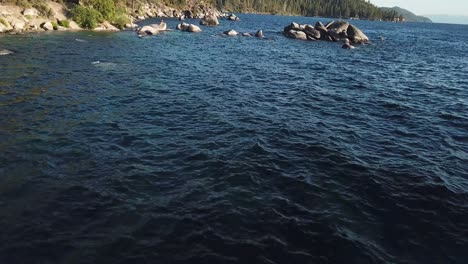 cinematic aerial view on lake water and coast on sunny day