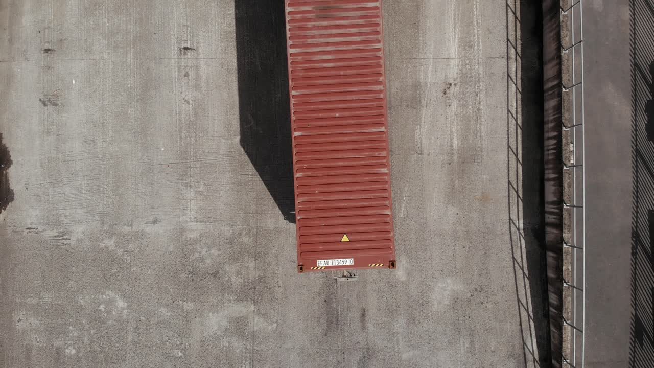 Top View Of A Container Van At The Loading Bay Of A Warehouse In Dublin, Ireland - aerial drone shot
