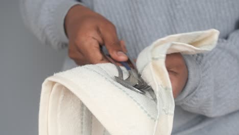 Person Drying Silverware with a Towel