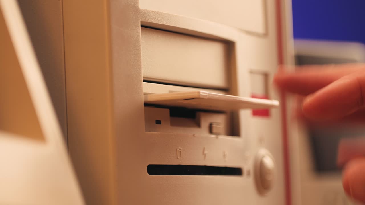 Using diskette for old computer. Music recorder, playing retro computer games. Vintage device for office, obsolete technology. . High quality 4k footage