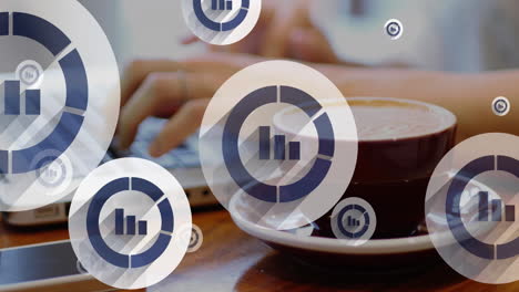 animation of graph icons close up of coffee cup, cropped hands of caucasian man working on laptop