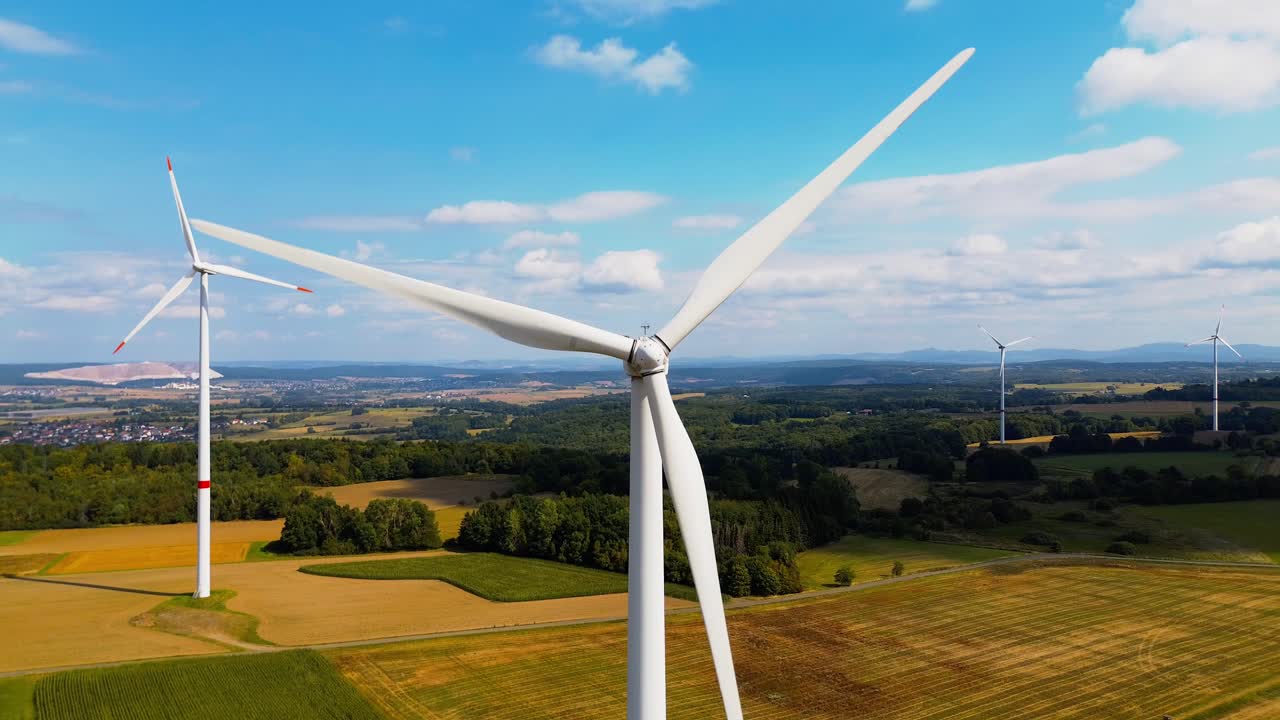 Close-Up Aerial View of Wind Turbine Blades Generating Renewable Energy in Countryside Landscape