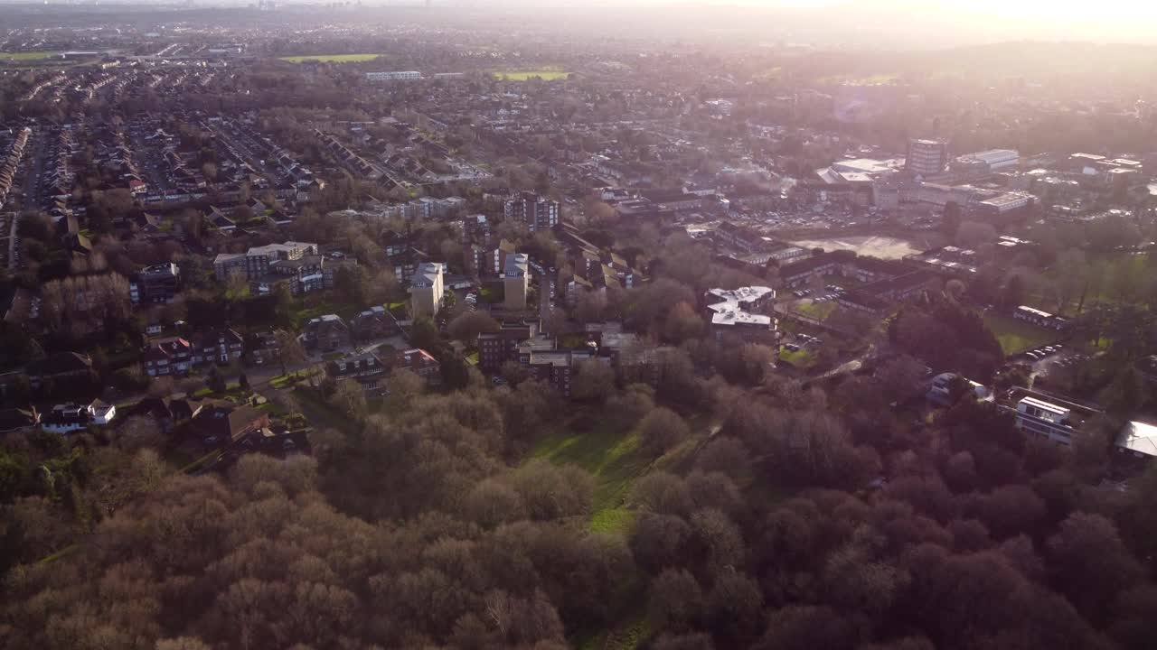 Slow moving drone shot flying over suburban town in England at sunset