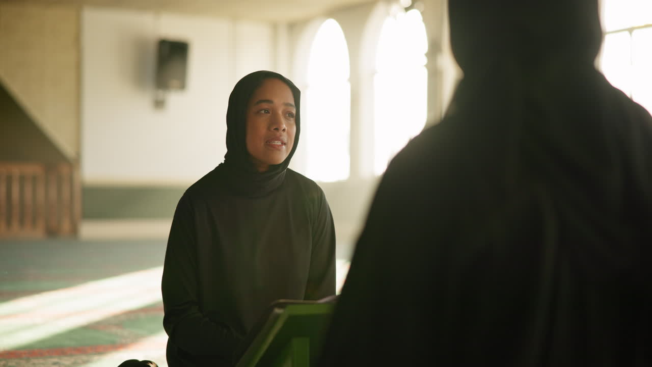 A Muslim woman wearing a hijab in a mosque