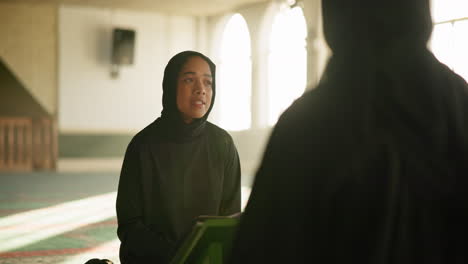 a muslim woman wearing a hijab in a mosque