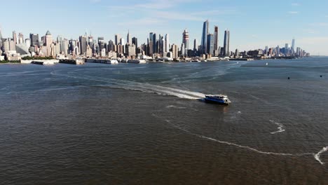 a drone shot over the hudson river capturing a beautiful nyc skyline