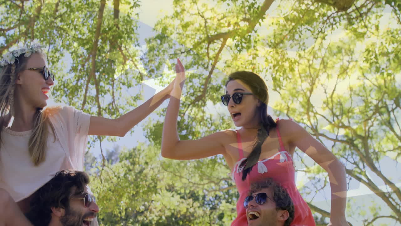 Under leafy trees, friends creating animation on sunny day outside together