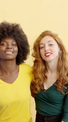 two happy diverse women smiling together