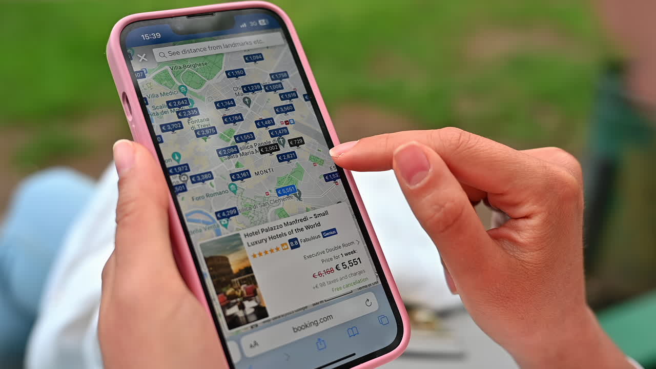 CHISINAU - MOLDOVA, MAY 26 - 2023: Woman searching for accomodation in Rome on Booking.com mobile phone app