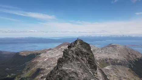 Two-mountaineers-on-top-of-a-mountain-with-the-sea-in-the-background-in-patagonia