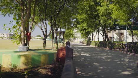 un lugar muy hermoso y pintoresco lleno de árboles, jardín al costado mientras pasa el camino