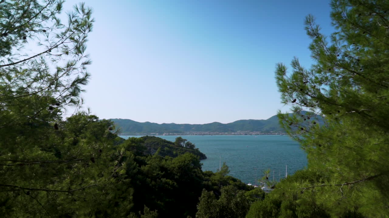 This shot depicts a panoramic view by of Marmaris harbor with a backdrop to pine-clad mountains.