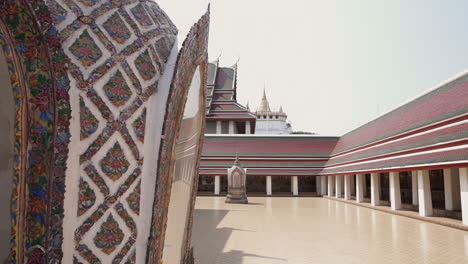 slow motion slide right to reveal the golden mountain buddhist temple in the city of bangkok in thailand from the grounds of another empty temple