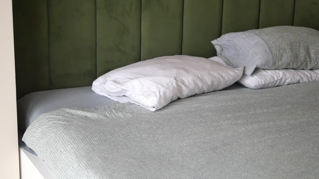 Bedroom with Green Headboard and Cozy Bedding