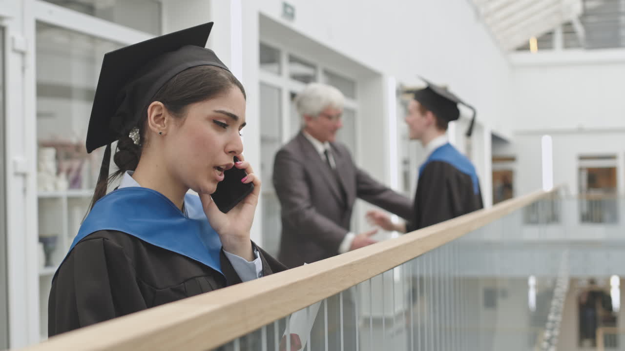 Cheerful Female Graduate Having Phone Call