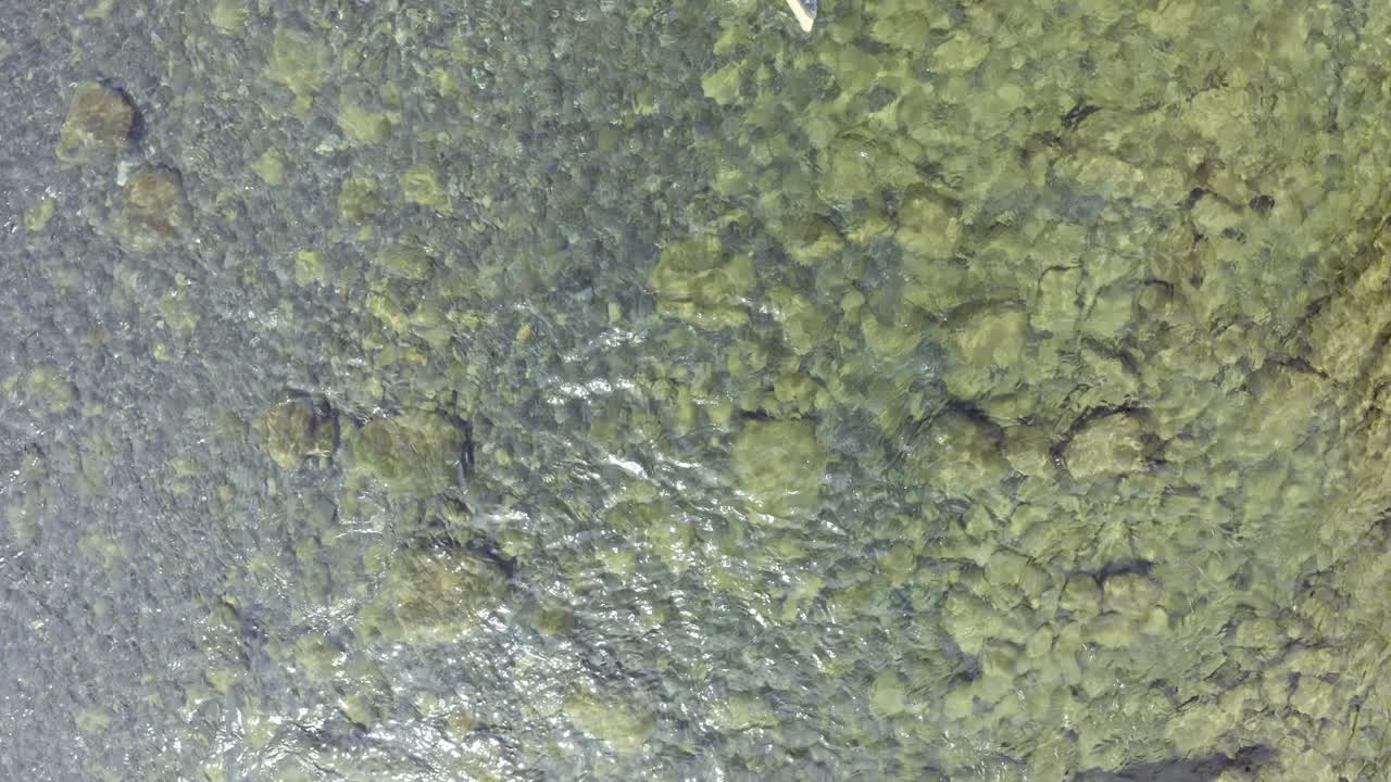 drone flotando y bajando sobre un hermoso río turquesa claro