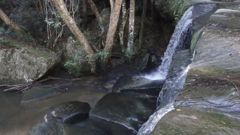 lower somersby falls with stone slabs close to sydney australia in the brisbane water national park, locked shot