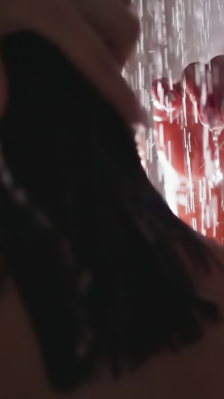 Woman does hair wash in shower water closeup. Brunette lady cleans short wet hair in bathroom. Comfortable hygienic routine and body-wash procedures