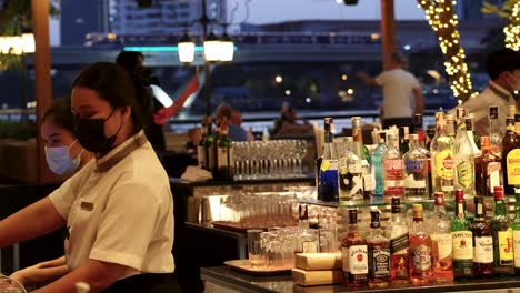 bartender preparing drinks in a lively atmosphere