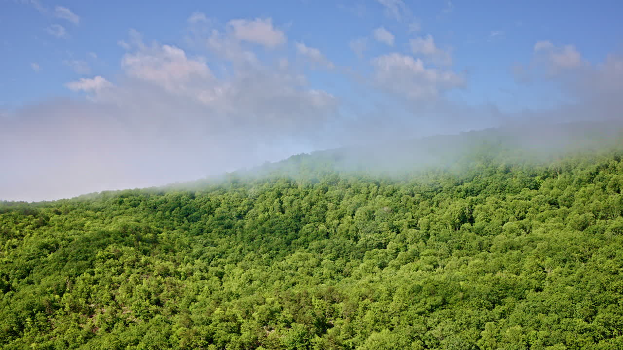 Elevated drone shot of mist blanketing the Smoky Mountains in NC