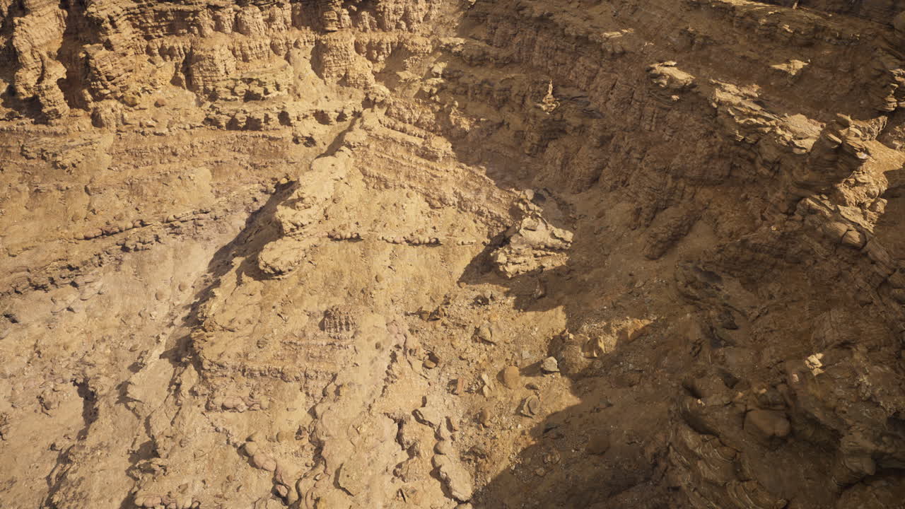 Rocky terrain exposed in a large mining pit at midday