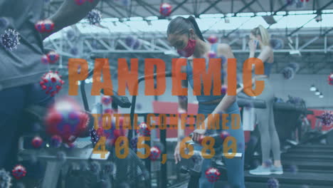 pandemic text with increasing cases against woman adjusting seat of stationary bike at gym