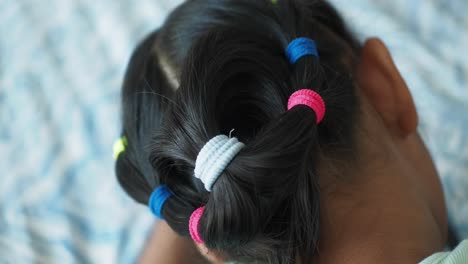 child's hairstyle with colorful hair bands