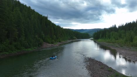 Tourists-Rafting-On-Flowing-River-Through-Forest-Near-Glacier-National-Park-In-Montana,-USA