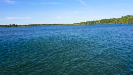 Footage-displays-beautiful-rural-lake-in-Estonia-Harjumaa-with-trees-in-the-background-and-vivid-colors