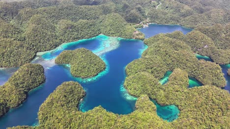 stunning aerial shot of sohoton cove in siargao, philippines, shows winding turquoise lagoons surrounded by green islets, dense tropical forest, and crystal-clear water, highlightingl bucas grande
