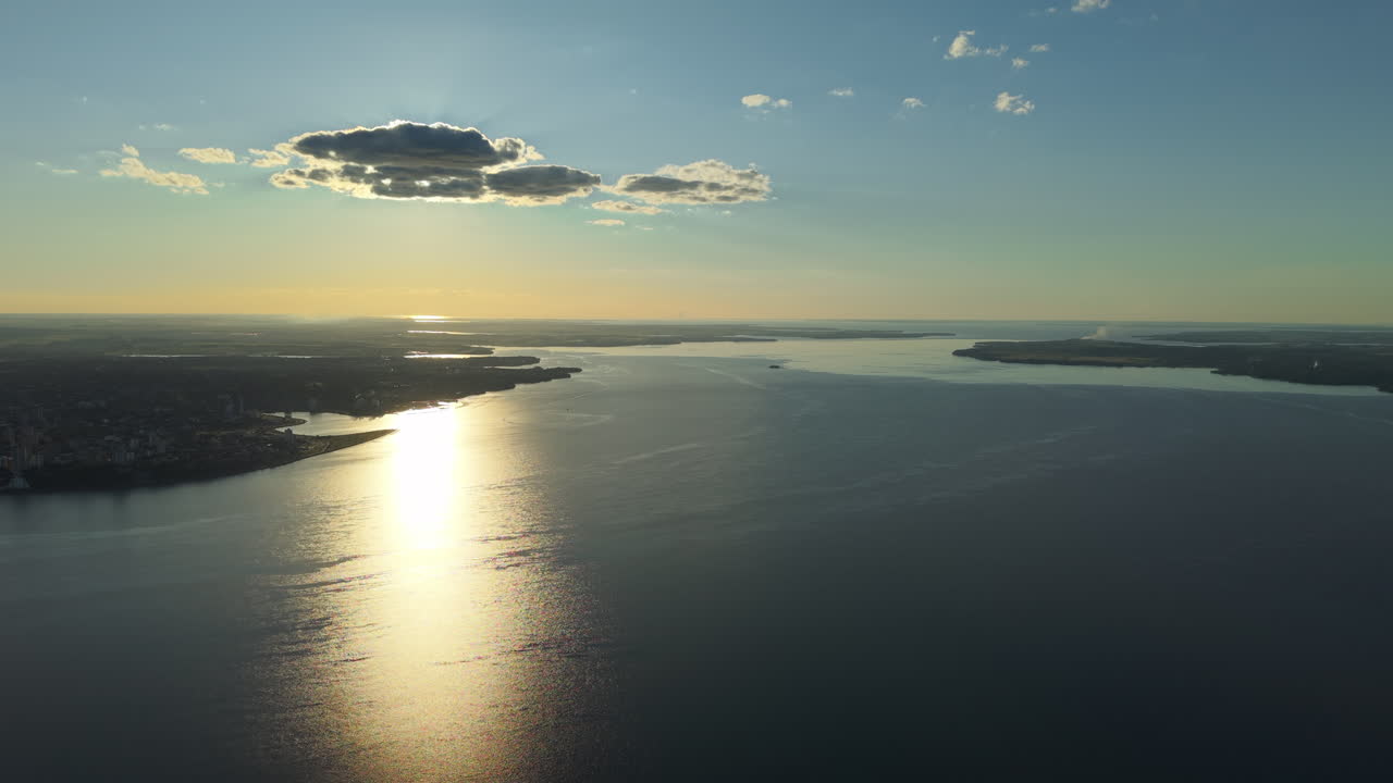 Drone Aerial view at Parana river, boarder between Argentina and Paraguay countries, sunset reflected on water landscape