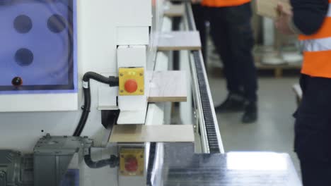 wooden mdf parts moving along a specially equipped conveyor. pvc edging.