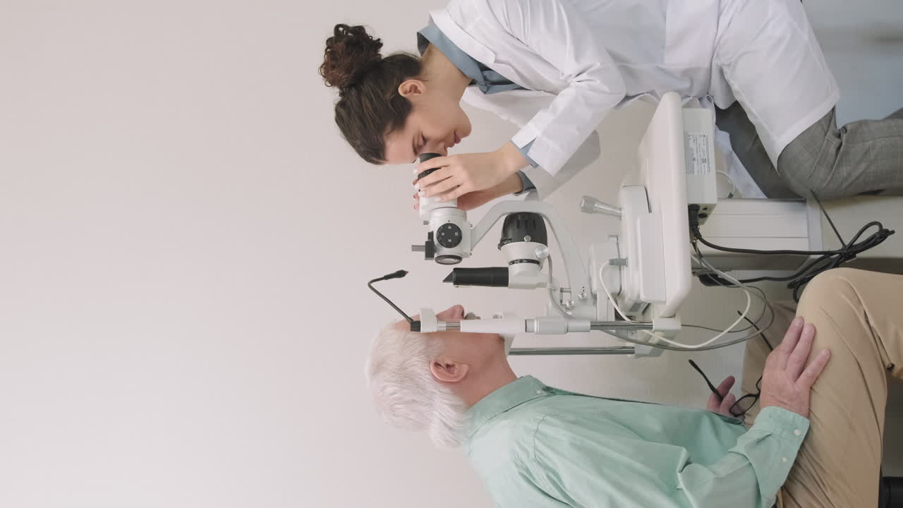 Senior Man Having Eyesight Examination In Clinic