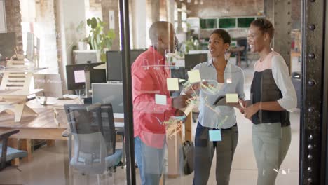 Happy-african-american-colleagues-taking-notes-on-glass-wall-and-discussing-work,-slow-motion