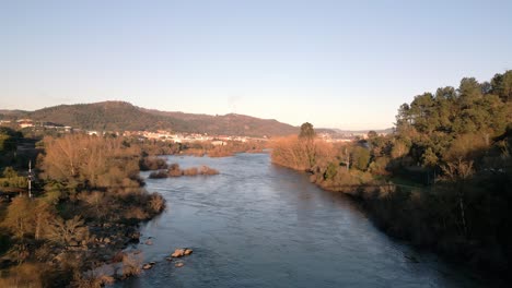 aerial shot over river miño in spain, great vegetation, horizon and blue sky