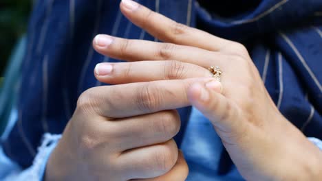 close up of womens hands with wedding ring ,