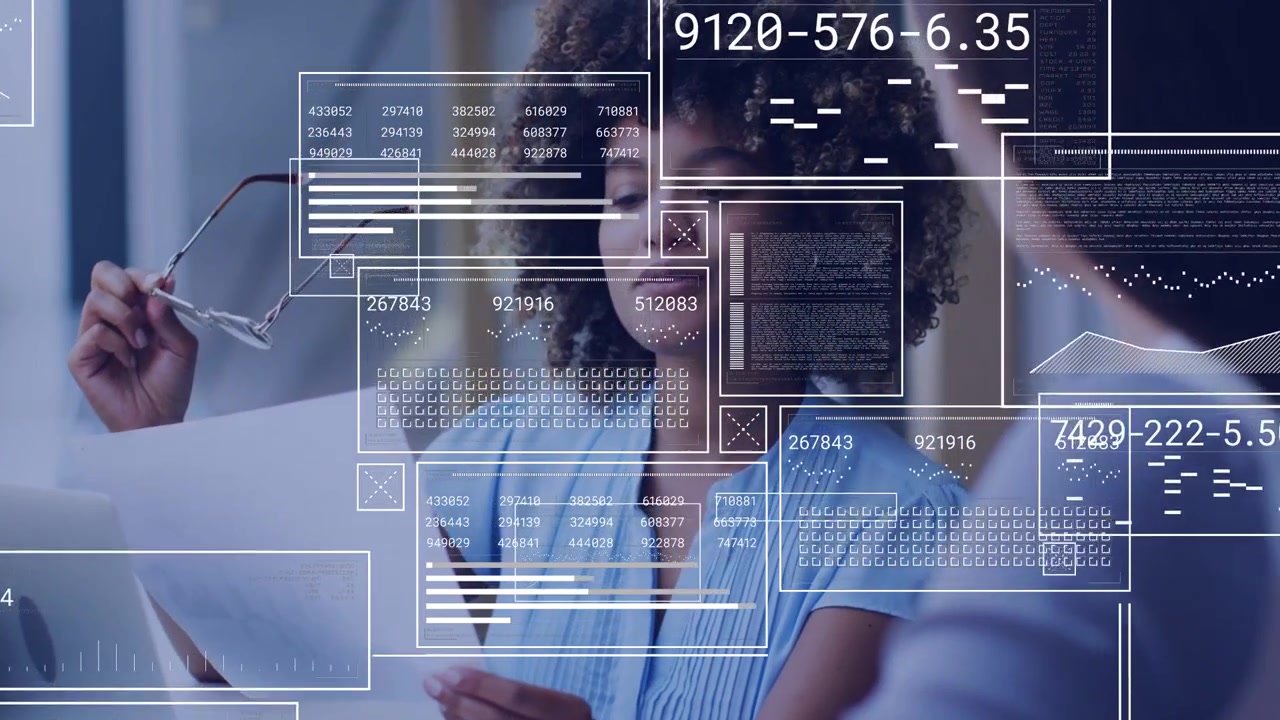 Woman reading paper and glancing at laptop, HUD charts appearing over paper during business meeting