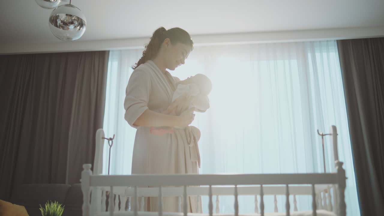 Mother holding her sleeping baby