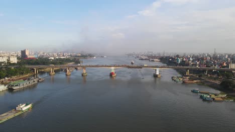 aerial flight over traffic on four lane postogola bridge over buriganga river