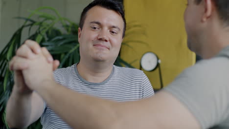 two men having a conversation and showing affection