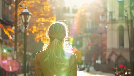 a woman walking down a city street in the fall